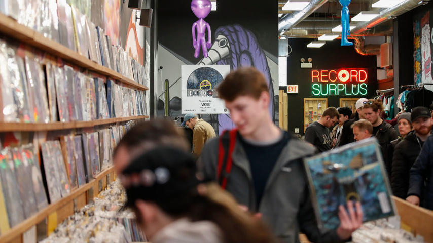 Customers shop at the Shuga Records store during the Record Store Day in Chicago on April 13, 2019. - Record Store Day was founded in 2007 and is now celebrated at stores around the world, with hundreds of recording and other artists participating in the day by making special appearances, performances, meet and greets with their fans, the holding of fund raisers for community non-profits, and the issuing of special vinyl releases. (Photo by KAMIL KRZACZYNSKI / AFP) (Photo credit should read KAMIL KRZACZYNSK